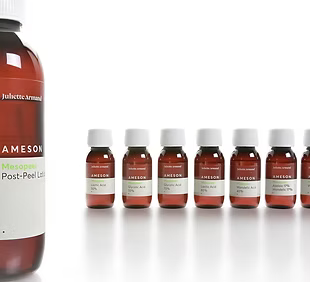 Row of Juliette Armand skincare chemical peel bottles on a white background